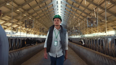 agribusiness owner walking shed control daily work at animal husbandry facility