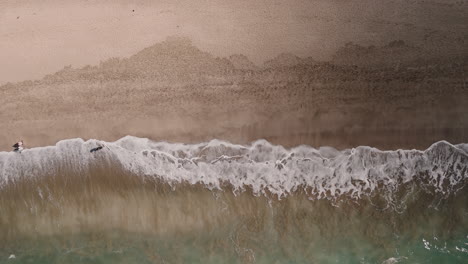 aerial view of a beach with waves
