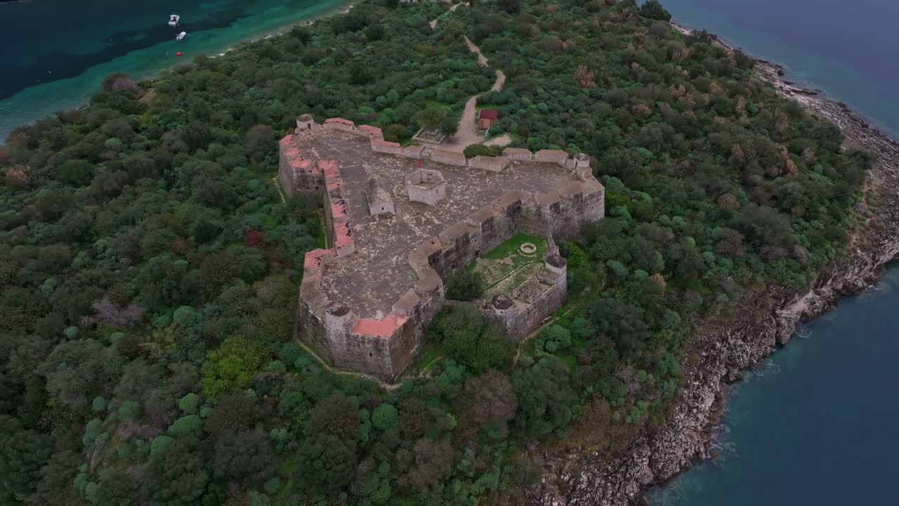 Aerial capture of Porto Palermo's fortress overlooking the blue sea