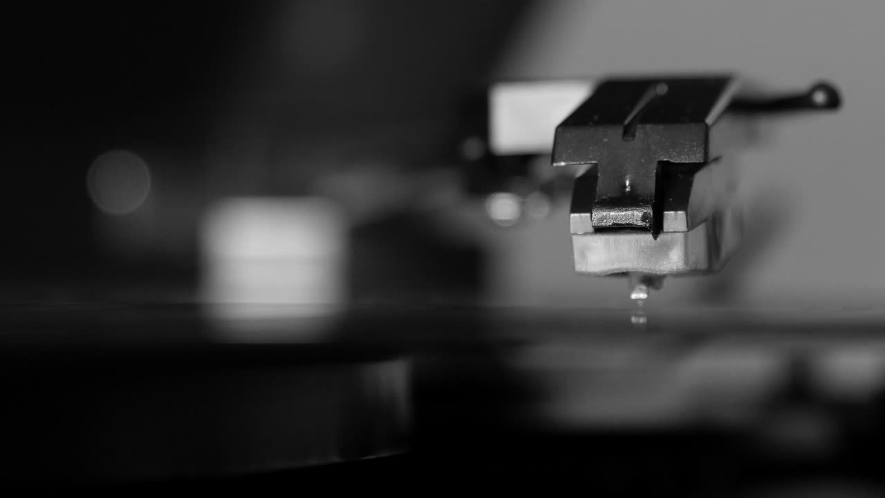 Turntable vinyl record player, man puts a vinyl record and includes a gramophone