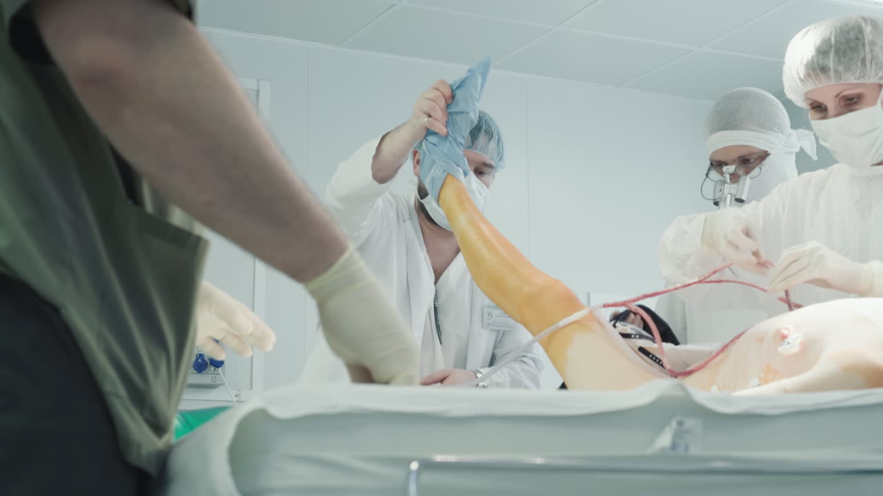 Man doctor raises leg of patient. Experienced surgical team prepares patient for coronary artery bypass surgery on operating table in hospital
