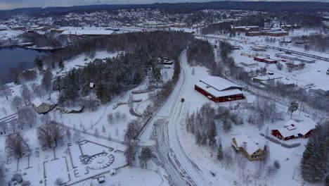 drone footage orbiting over a cemetery while a tractor clearing the street from snow