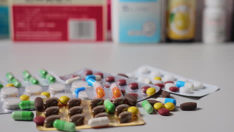 Antibiotic-drug-resistance,-many-colorful,-red,-yellow-pills-and-capsules,-packaging-with-medicines