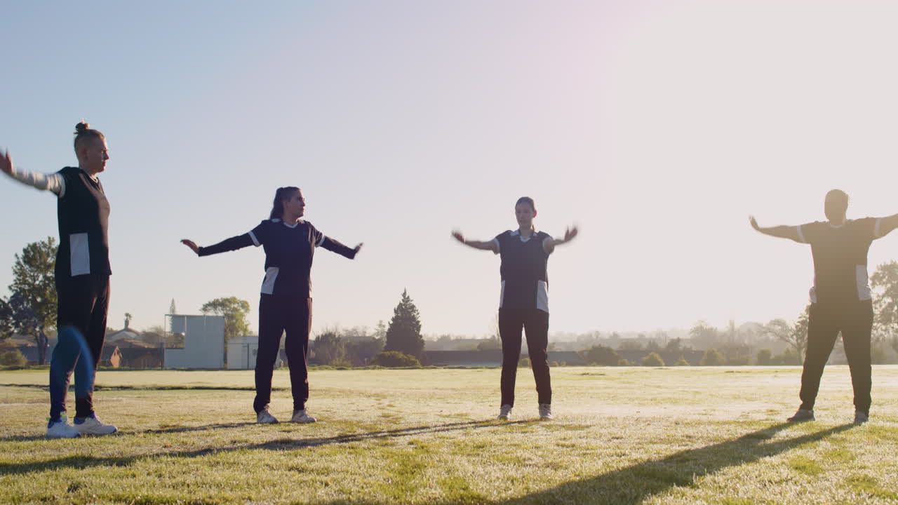 Exercising outdoors, women warming up for cricket practice on sunny day