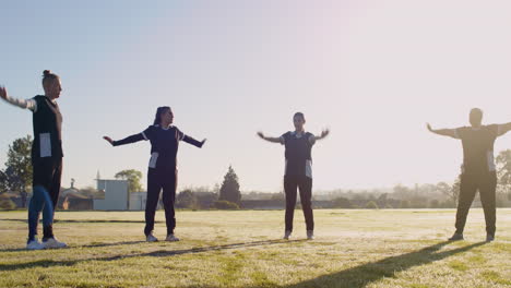 exercising outdoors, women warming up for cricket practice on sunny day