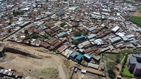 poor country of kenya nairobi kibera slums people walking in the poorly constructed roads