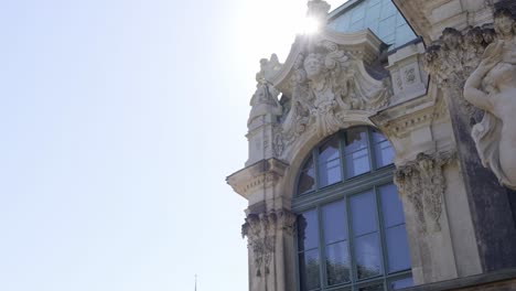 sunlight transforms building facade into stunning cityscape event. the sun’s rays illuminate the building’s windows, casting light on the medieval architecture and colorful facade amidst the city