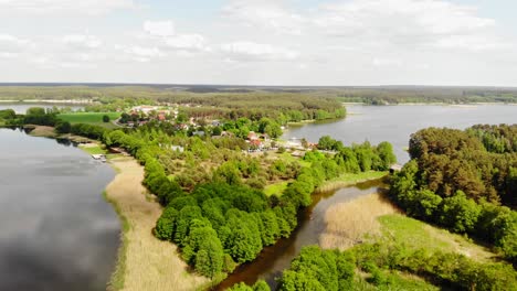 panoramic view of nature park with small community surrounded by lake and vegetation in styporc, gmina chojnice, poland