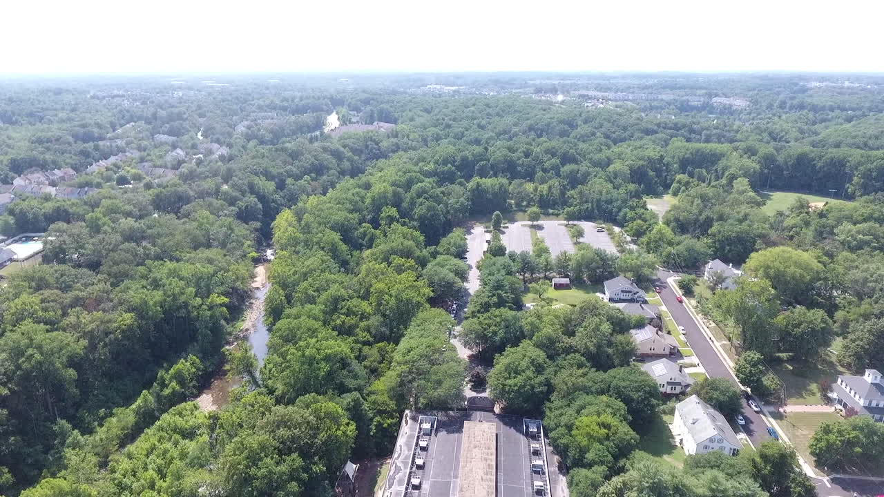 AERIAL PAN OUT OF WOODS