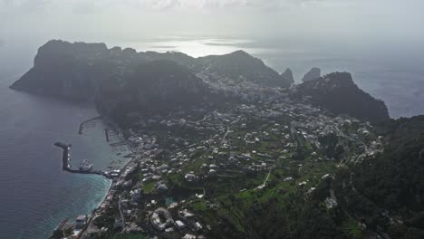 Aerial-shot-of-Capri-Island-in-Italy,-showcasing-the-stunning-landscape-and-coastal-town-in-daylight