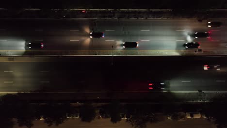 una toma cinematográfica en la noche sobre el tráfico en una carretera oscura