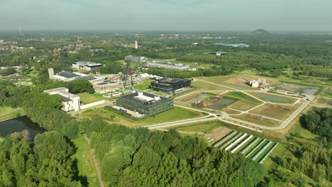 Aerial-flying-towards-Thorpark-scientific-and-technological-park,-Belgium