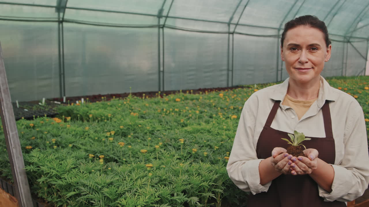 Portrait of Woman with Seedling in Hands