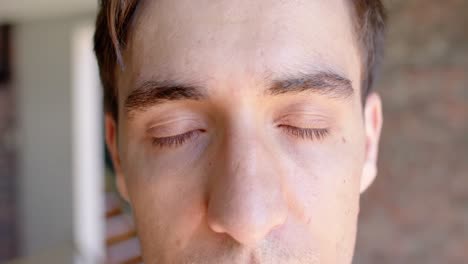 close up portrait of opening eyes of casual caucasian businessman, slow motion