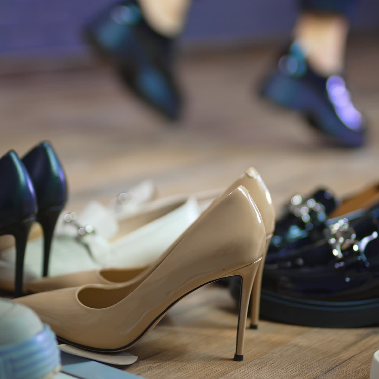 Diversity of footwear for female customers. Close up. Model in black lacquered shoes running at backdrop in blur