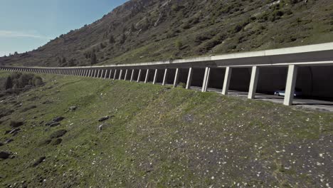 Aerial car driving in tunnel in beautiful calming mountain alps summer sunny landscape, K&uuml;htai, Austria
