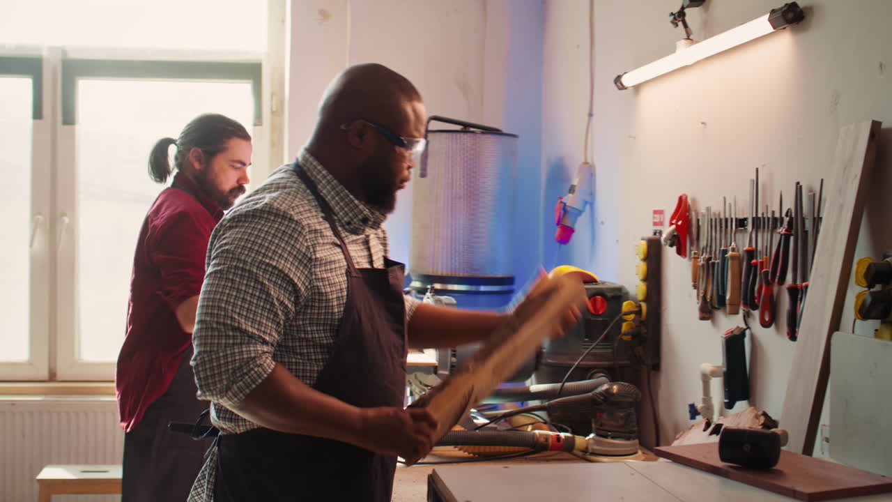 Cabinetmaker evaluates timber block, picking right tool from rack