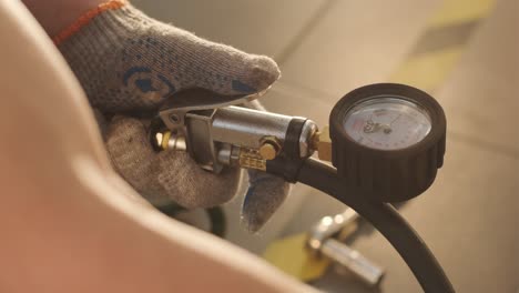 filling the wheel with air from the compressor at the service station.