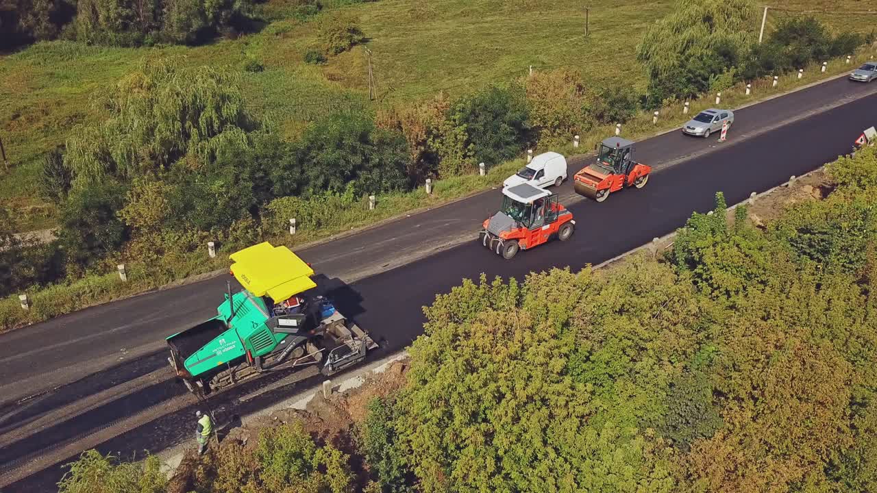 Aerial view. Laying a new asphalt on the road. Construction of the road