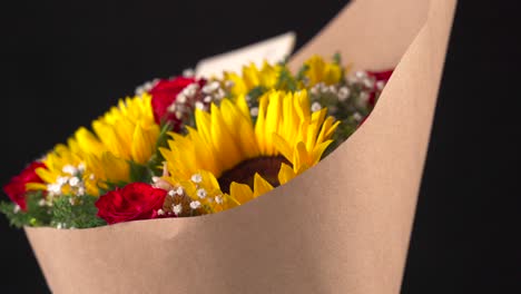 sunflowers and roses arrangement bouquet spinning medium shot black background