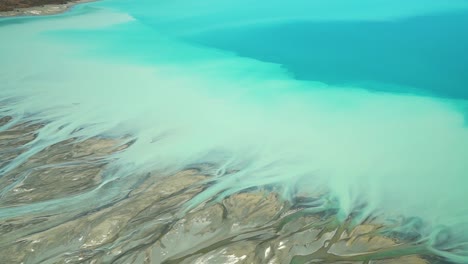 Detail-of-braided-rivers-at-beatiful-blue-glacier-Lake-Pukaki,-Aoraki-Mount-Cook-National-Park,-Southern-Alps,-New-Zealand-from-airplane-scenic-flight