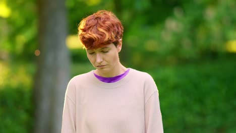 portraits of a woman with red hair in a park