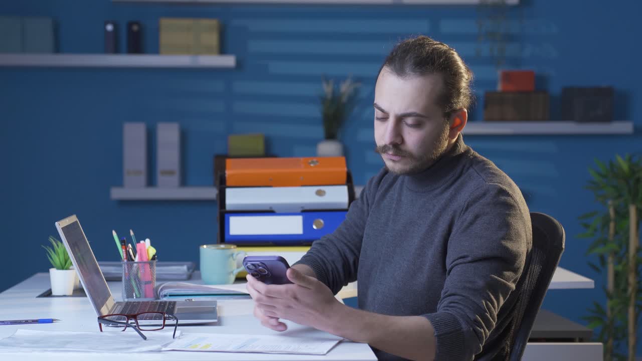 Hearing bad and sad news on the phone, the man is frustrated.