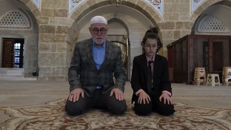 Grandfather-and-grandson-perform-salaat