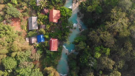Top-down-view-of-famous-Kuang-si-waterfall-at-Laos,-aerial