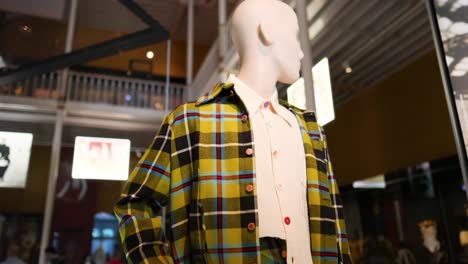 mannequin in plaid outfit at museum exhibit