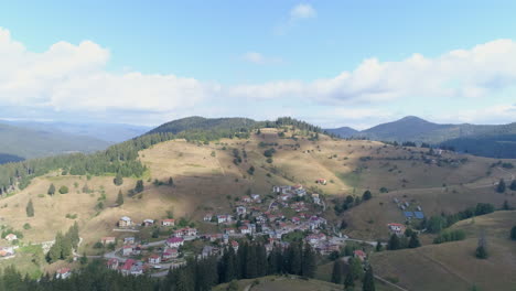 AERIAL:-a-small-village-in-a-valley-between-hills