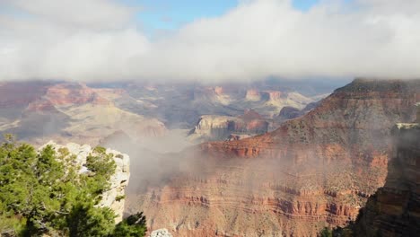 clouds slowly coming out of the grand canyon