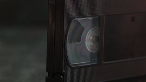 dolly-in close-up of a vintage retro vhs movie cassette, video tape