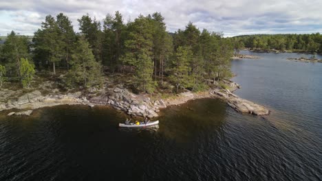 canoers paddling between islands on a big scandinavian lake in glaskogen