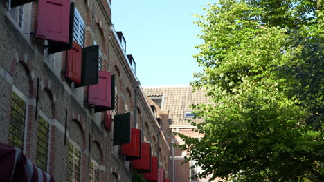 brick exterior with red shutters of weeshuis gouda hotel in gouda, netherlands