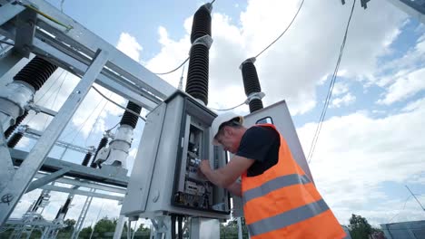 electrical engineers inspect the electrical systems at the equipment control cabinet