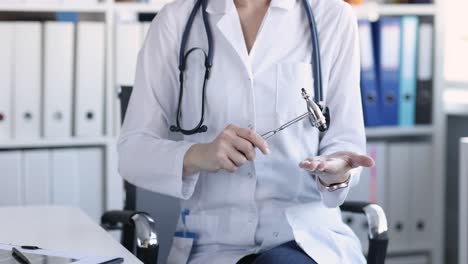 doctor holding a reflex hammer
