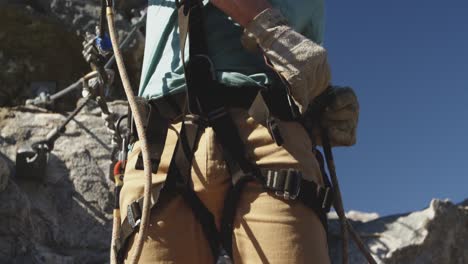 young caucasian man fastening zip lining harness