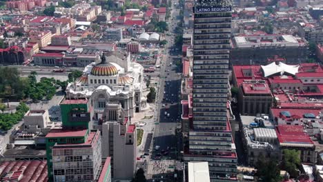 aerial shot of a skyscraper and the the palace of fine arts in mexico city
