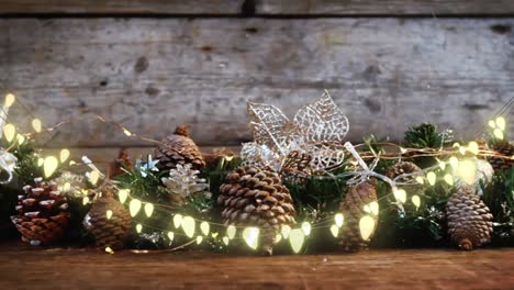 animation of lights over christmas tree decorations on wooden background