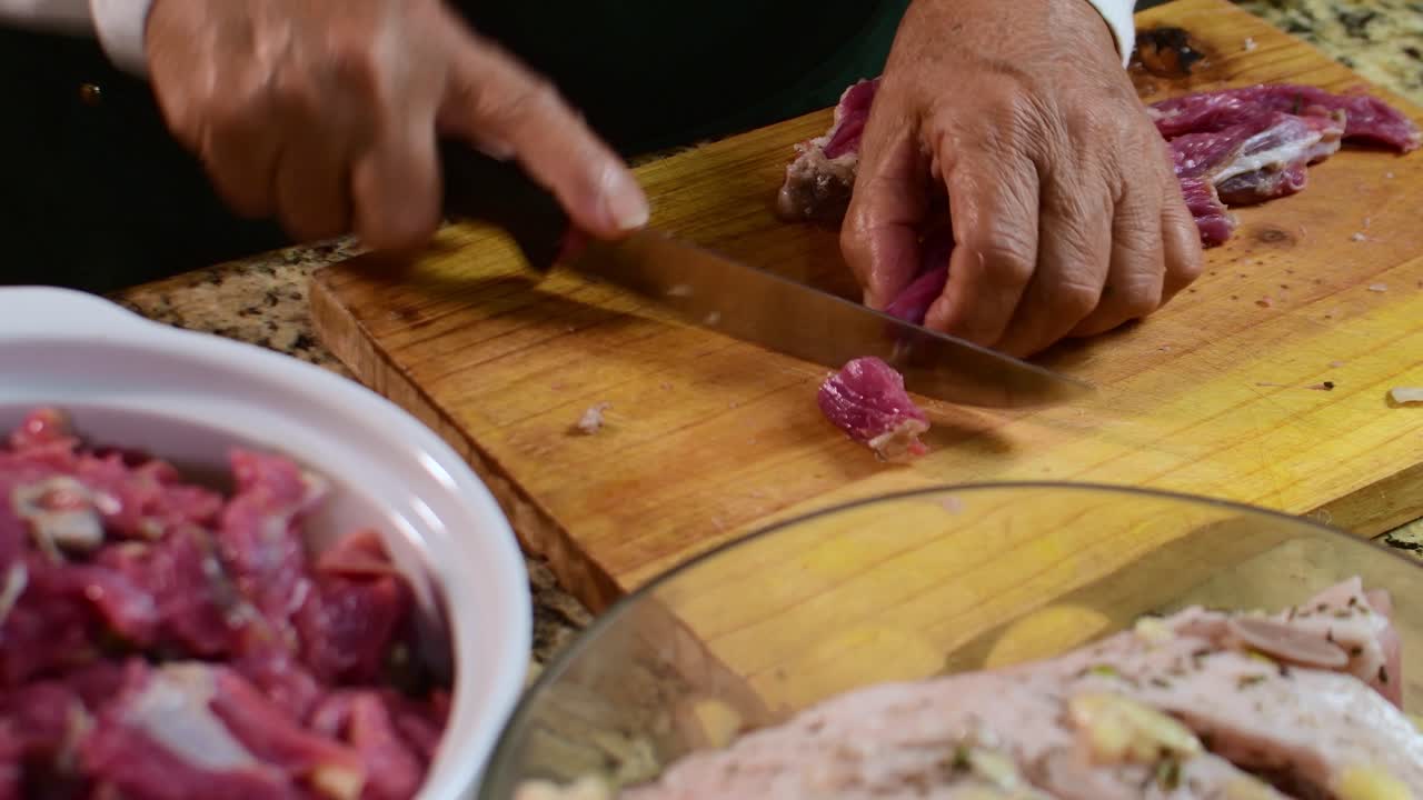 kitchen scene includes glass bowls with marinated poultry and herbs on a granite countertop, showcasing the meticulous "mise en place" for a festive traditional dish