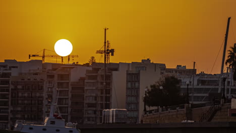 gzira, malta during a golden sunset - zoomed in telephoto time lapse of nightfall