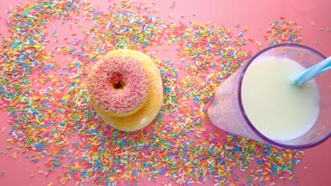 pink donuts and milk with sprinkles