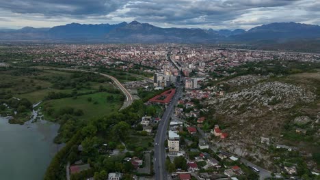 aerial view of shkoder - albanian city on the banks of buna river in northern albania, albania. tilt-up shot