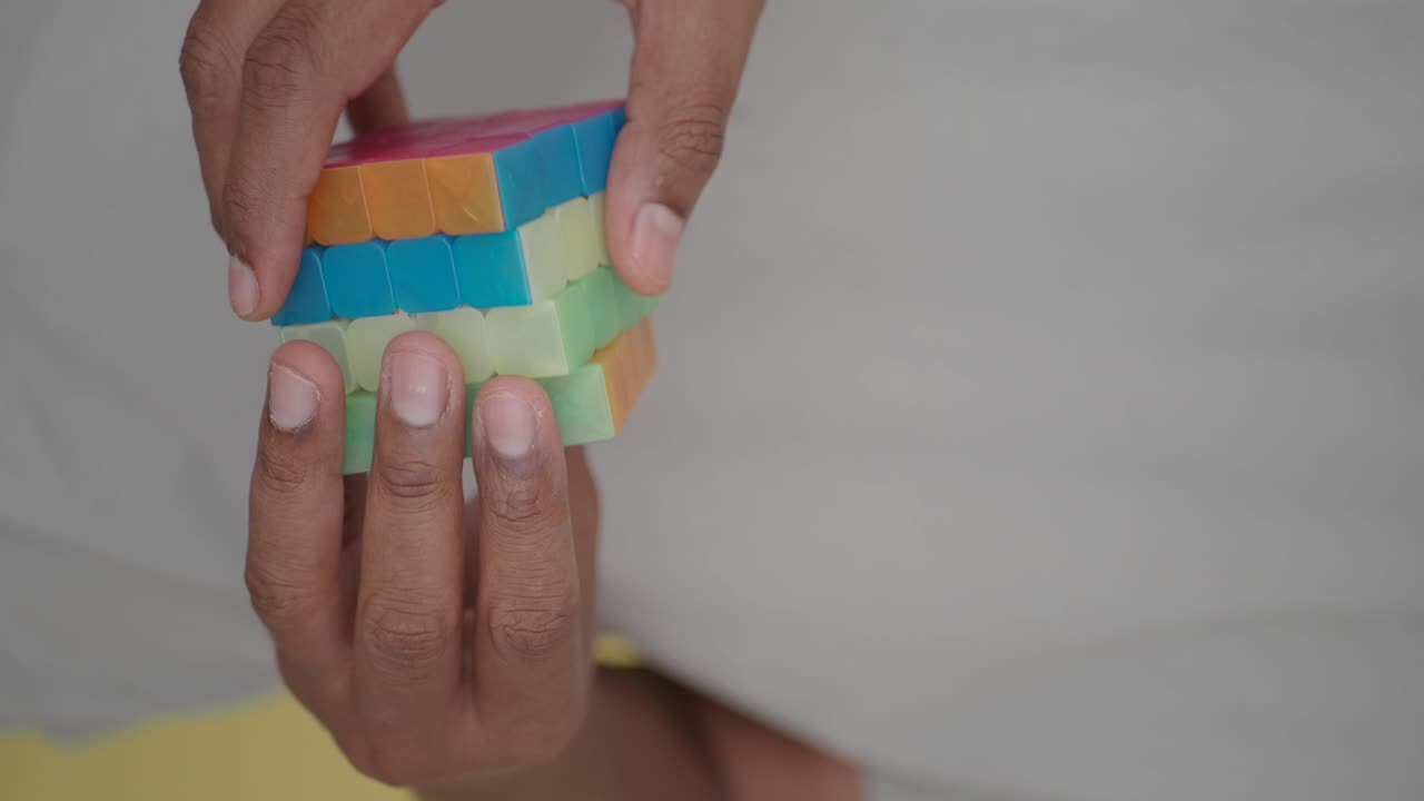 Hands solving a Rubik's cube