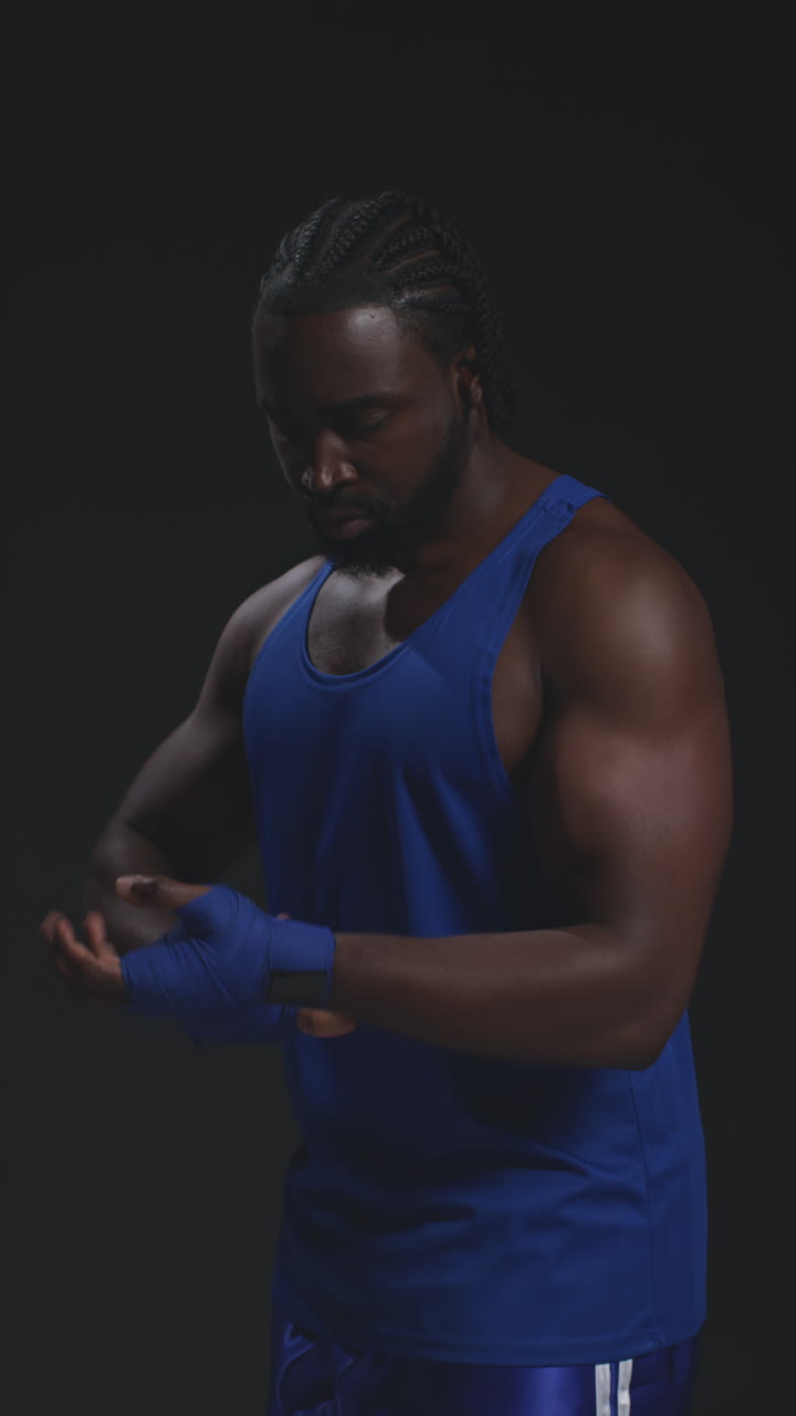 Vertical Video Of Male Boxer Wrapping Hands With Protective Bandages Before Boxing Match Or Training Session 2