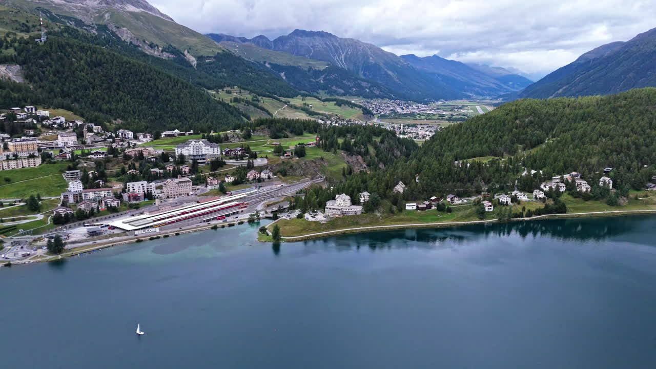 Aerial view of serene St. Moritz lake with mountain backdrop in Switzerland