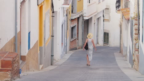 woman tourist is vverhpo narrow street in the old quarter of the old city lloret de mar spain touris