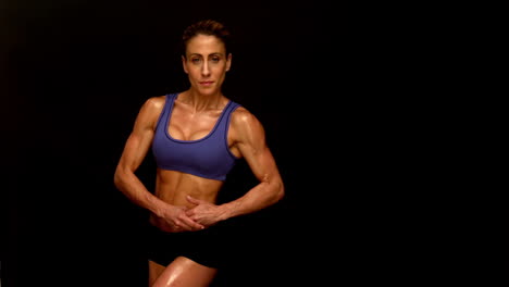 muscular woman flexing towards camera