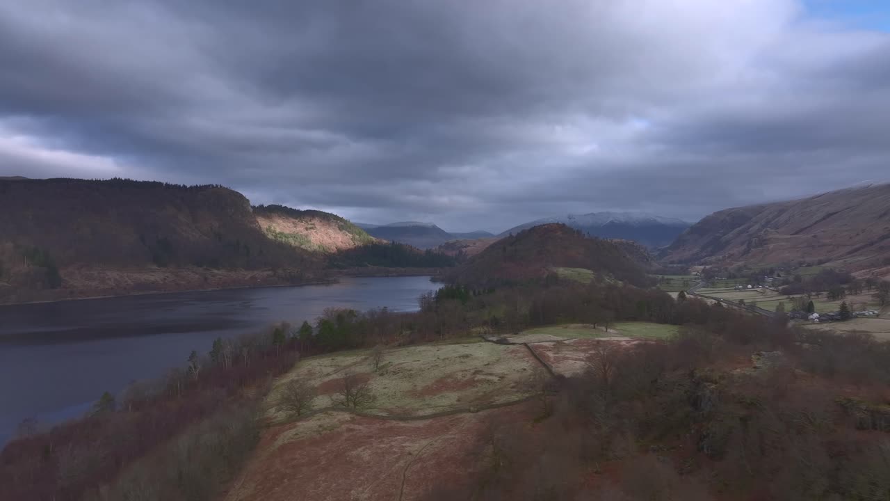 Lateral flight over landscape towards lake at dawn.Lake District, Cumbria, UK.